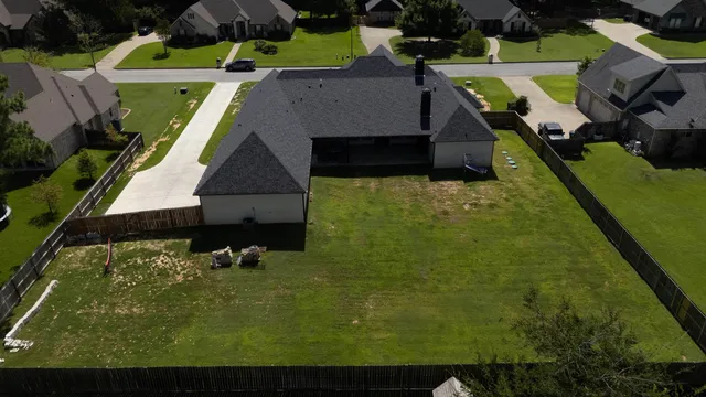 an aerial view of multiple houses with yard