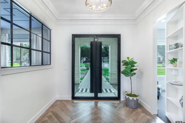 a view of entryway with window and wooden floor