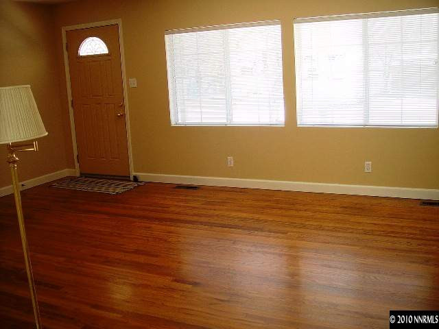 1125 Jonada Place Reno, NV 89509 - Photo 2 of 9 a view of an empty room with wooden floor and a window