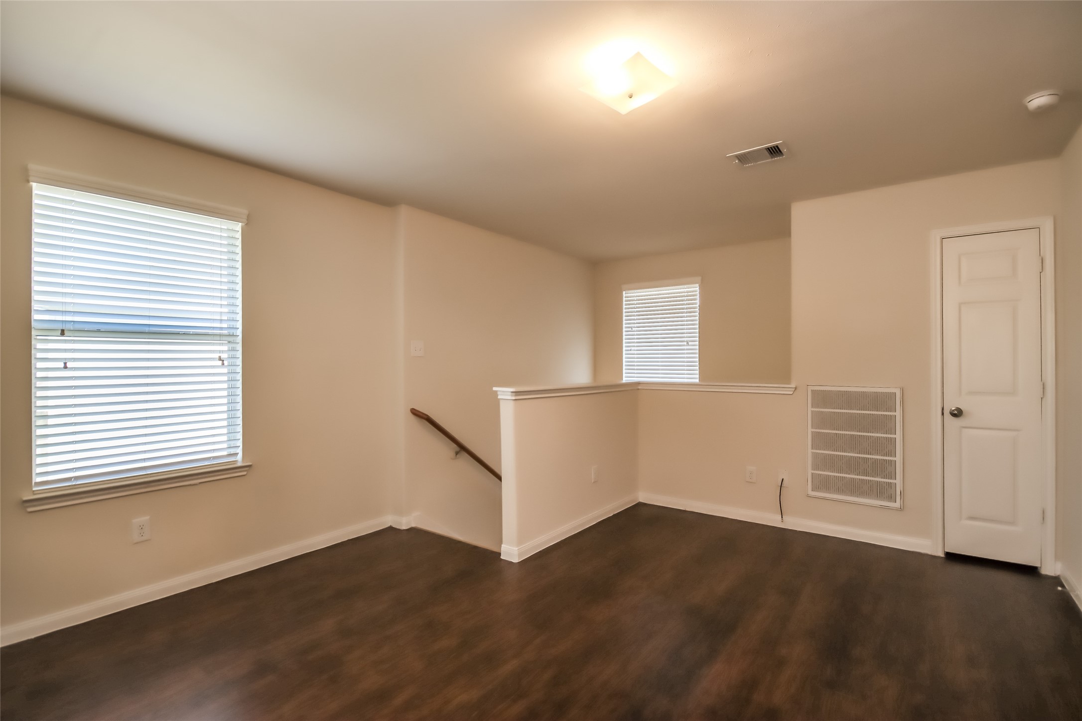 13022 Ristina Circle Houston, TX 77048 - Photo 9 of 15 an empty room with wooden floor and windows