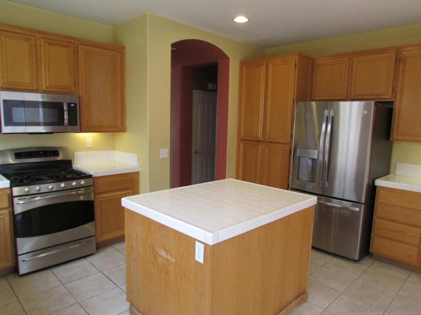 757 Aldea Drive Oceanside, CA 92057 - Photo 4 of 11 a kitchen with a refrigerator sink and stove