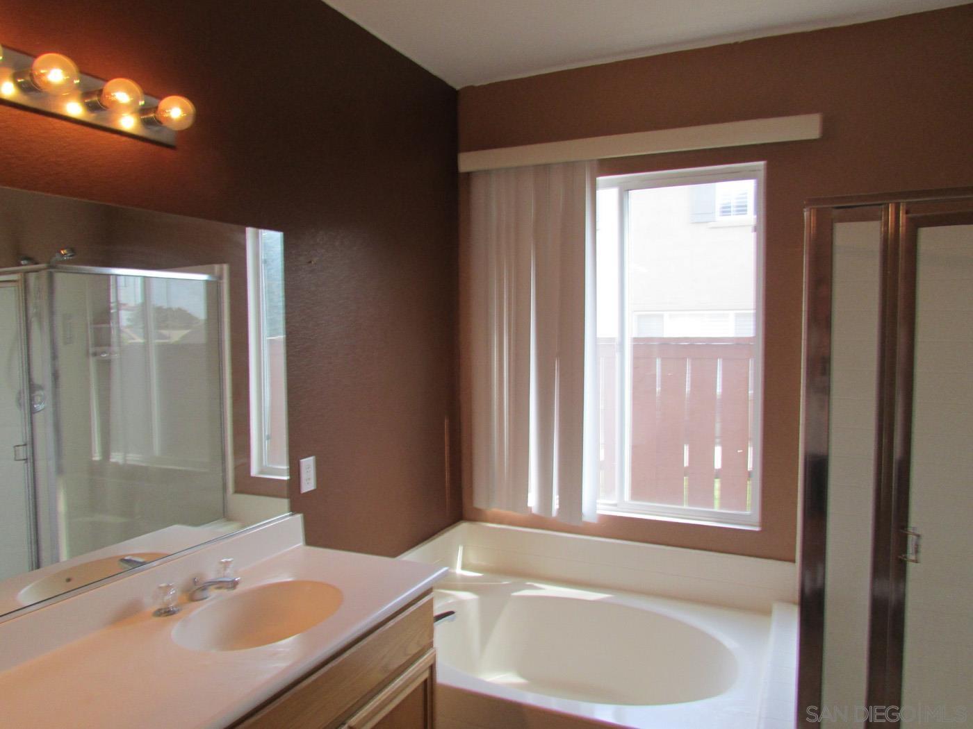 757 Aldea Drive Oceanside, CA 92057 - Photo 10 of 11 a bathroom with a tub sink and mirror