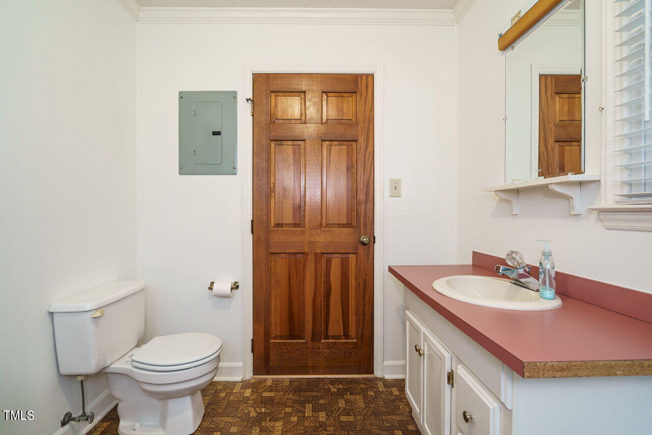 5917 Countryview Lane Raleigh, NC 27606 - Photo 12 of 43 Discover an efficient space that combines convenience and functionality. The half bath and laundry area seamlessly coexist in this home, making everyday tasks a breeze.