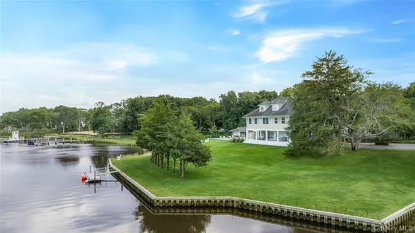 a view of a house with pool and a yard