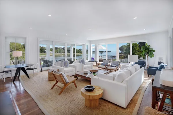a living room with fireplace furniture and a potted plant