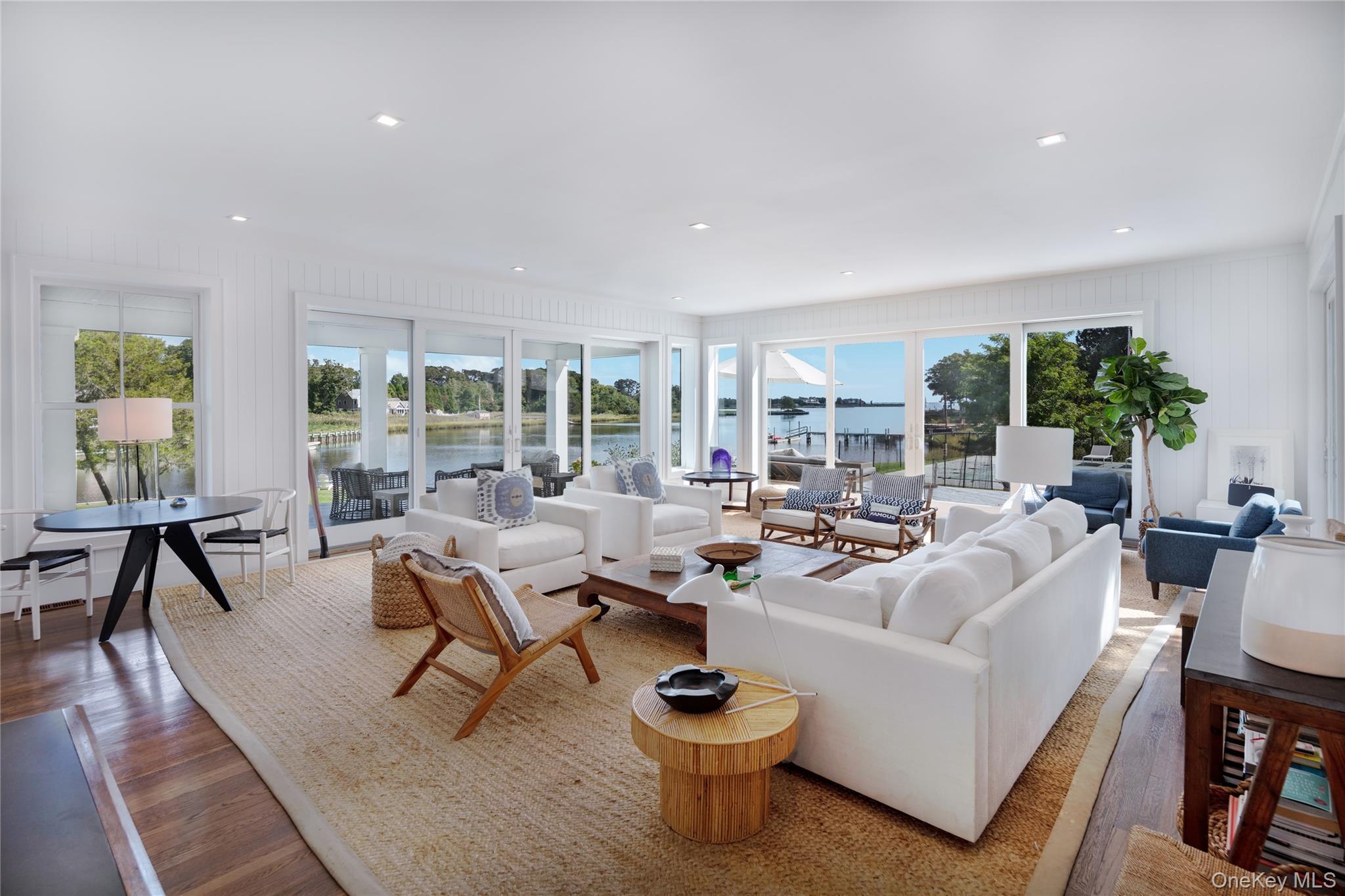 11 Bay Road Quogue, NY 11959 - Photo 11 of 41 a living room with fireplace furniture and a potted plant