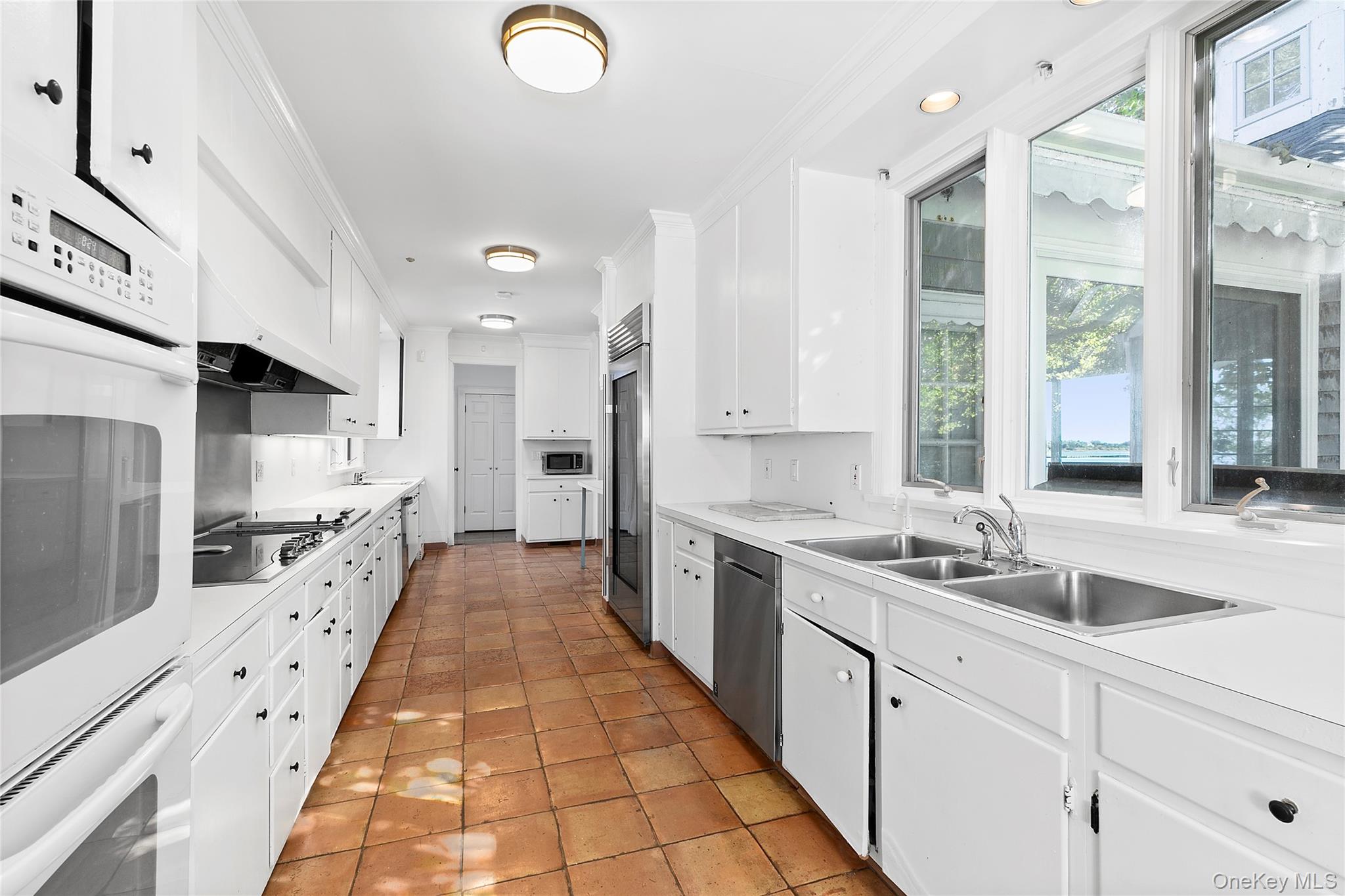 11 Bay Road Quogue, NY 11959 - Photo 14 of 41 a large white kitchen with a large window