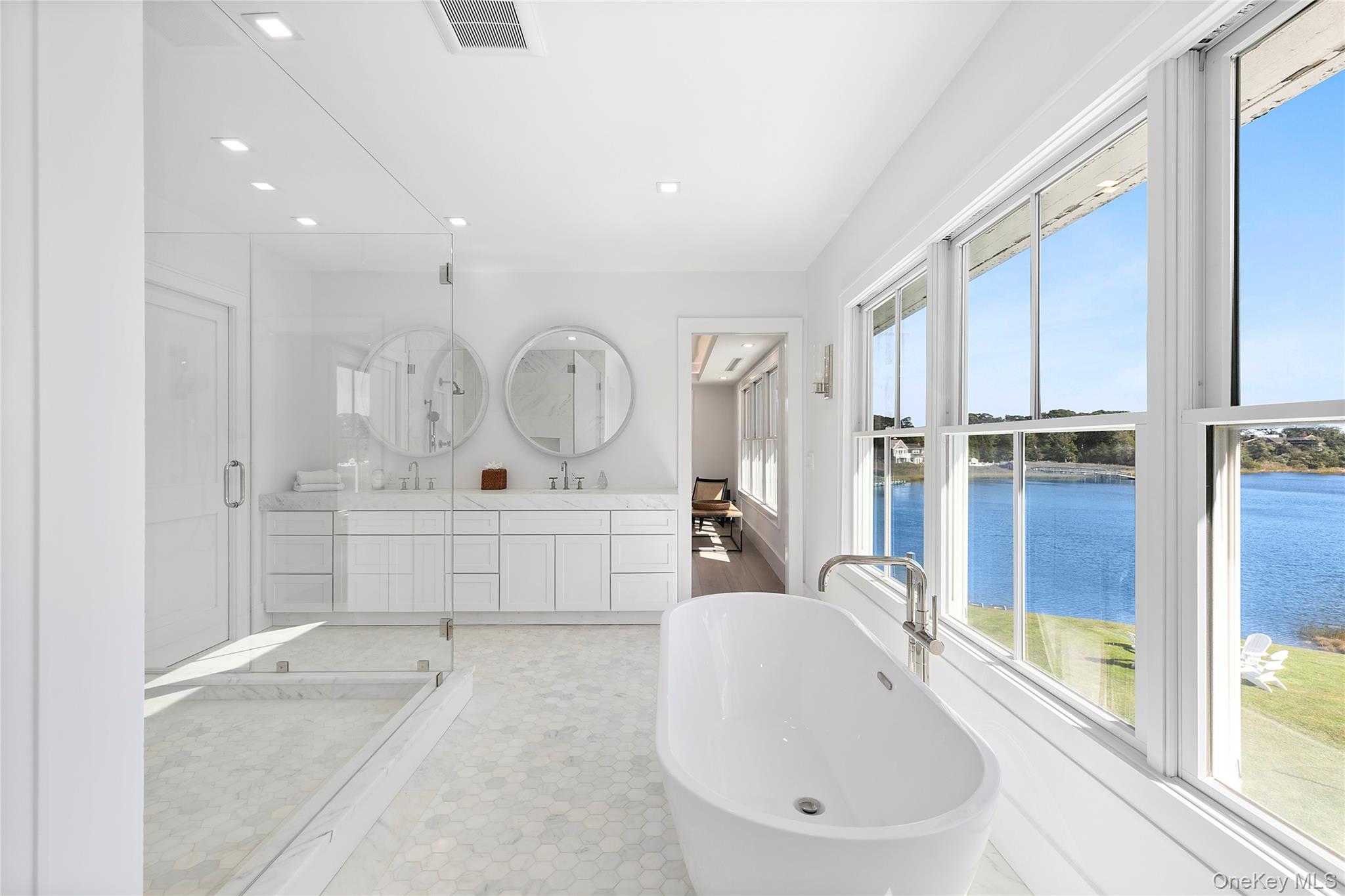 11 Bay Road Quogue, NY 11959 - Photo 18 of 41 a bathroom with a tub sink and mirror