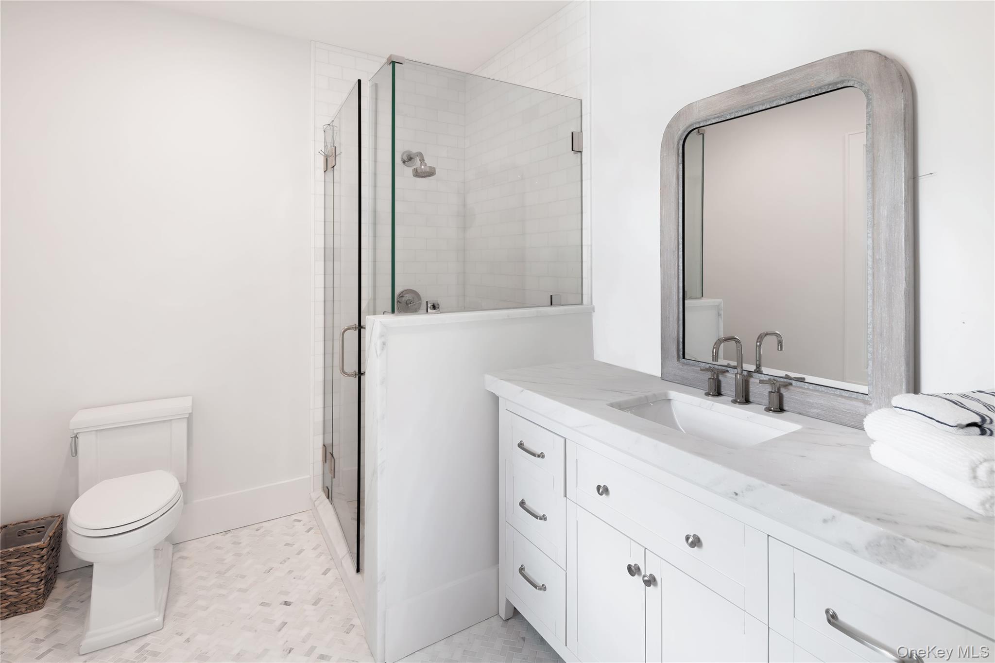 11 Bay Road Quogue, NY 11959 - Photo 20 of 41 a bathroom with a granite countertop sink a toilet and a mirror