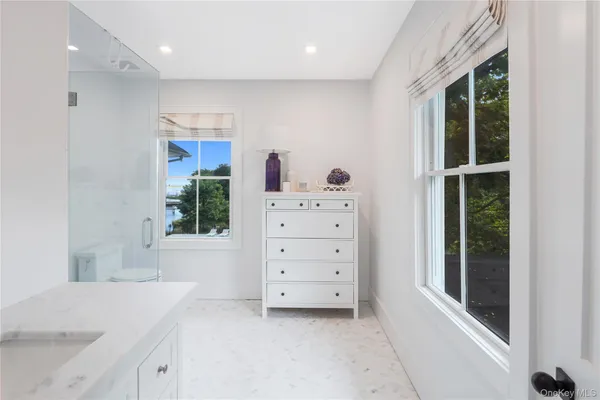 a view of a bedroom with furniture and windows