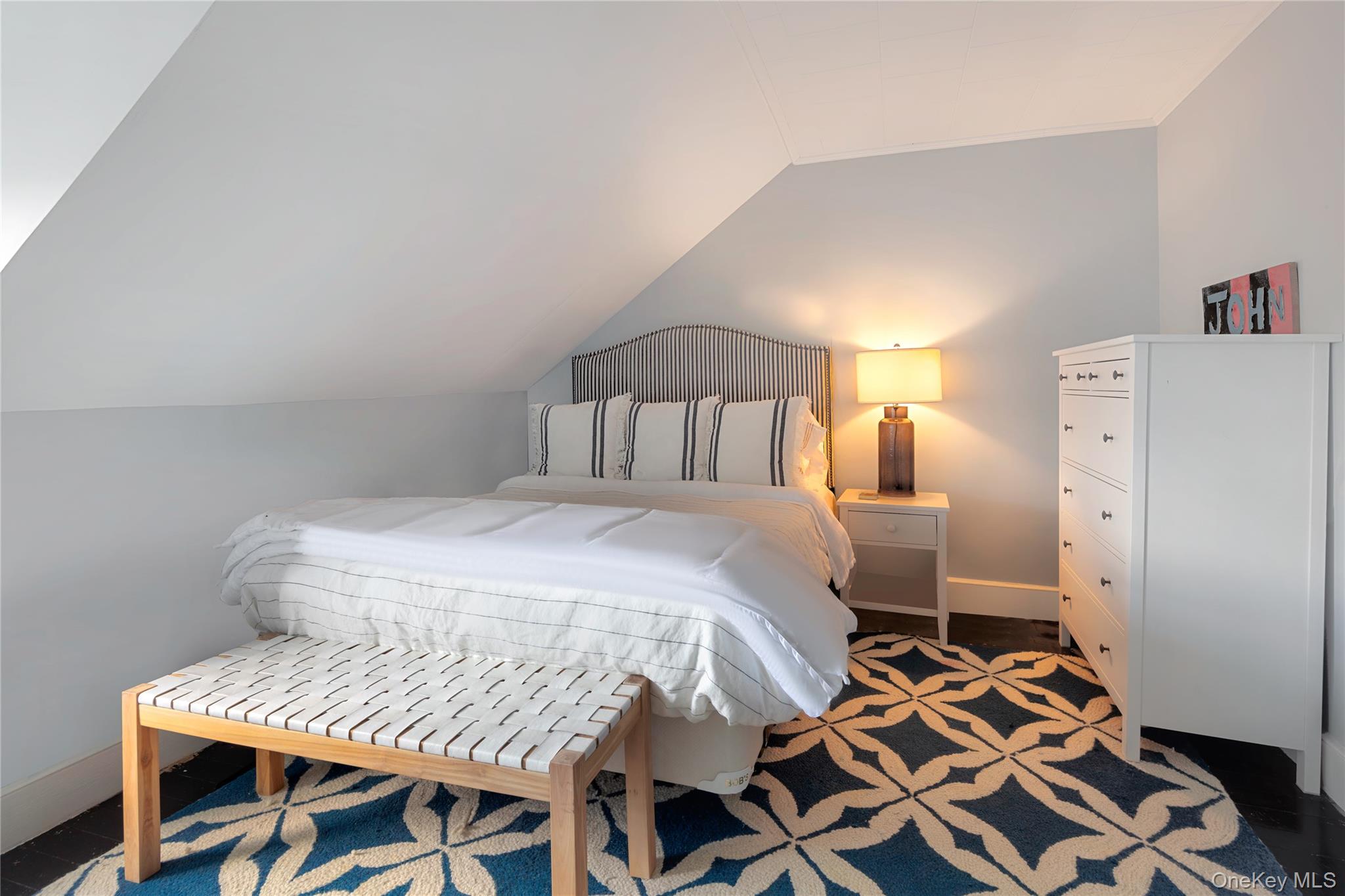 11 Bay Road Quogue, NY 11959 - Photo 23 of 41 a bedroom with a bed and a table in it