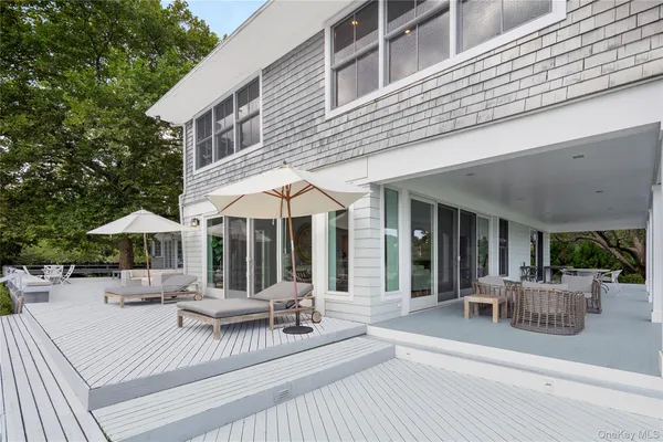 a view of a dinning table and chairs in patio of the house
