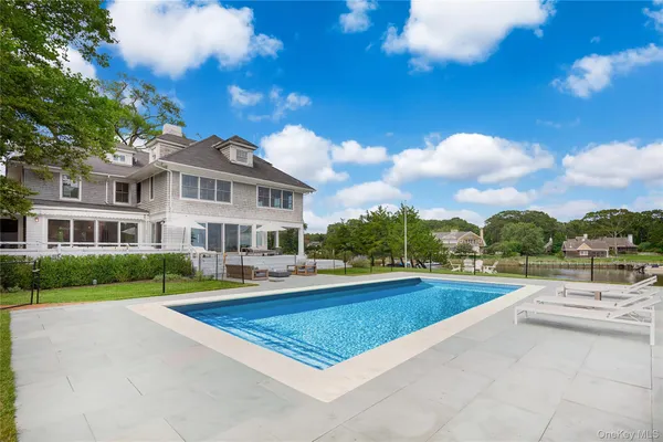 a view of a house with swimming pool and a yard