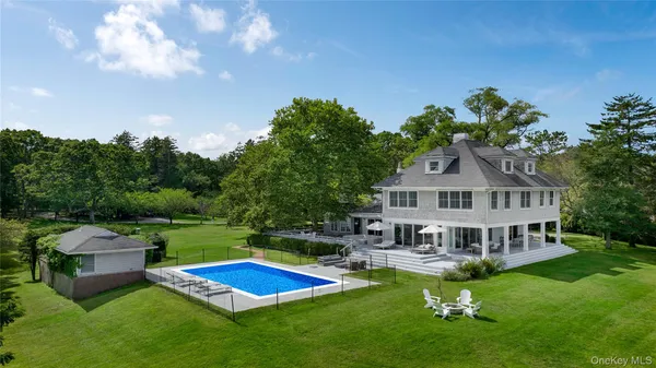 a view of a house with pool and a yard