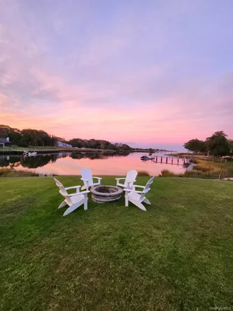 a view of a lake with houses in the back