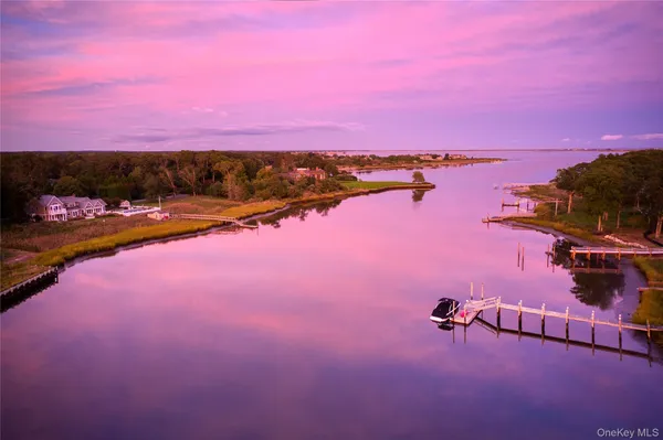 an aerial view of a swimming pool with lawn chairs and red yard