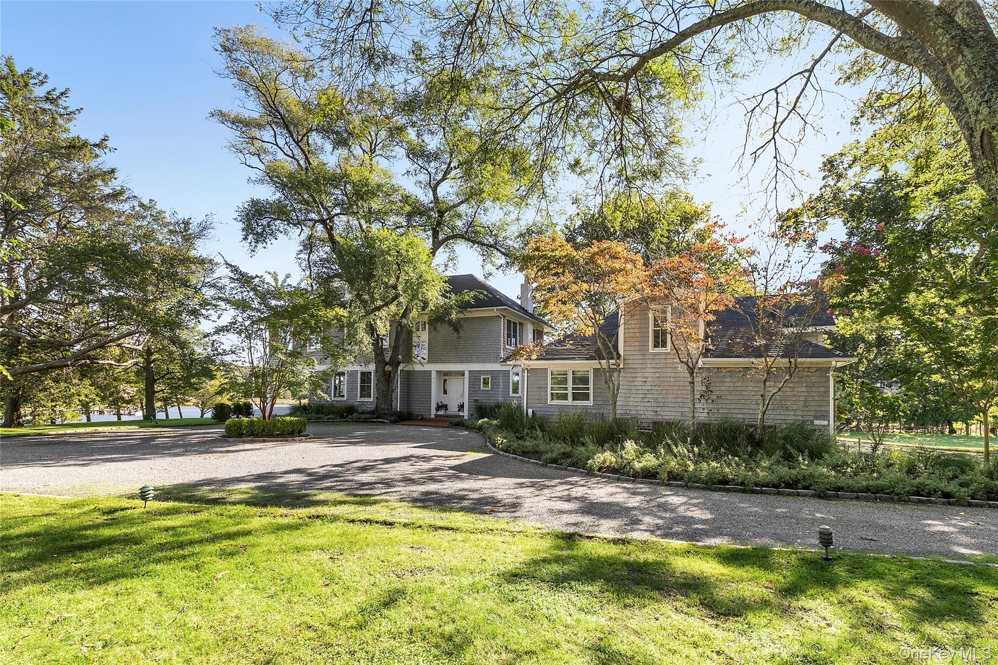 11 Bay Road Quogue, NY 11959 - Photo 4 of 41 a view of swimming pool with outdoor seating and house in the background