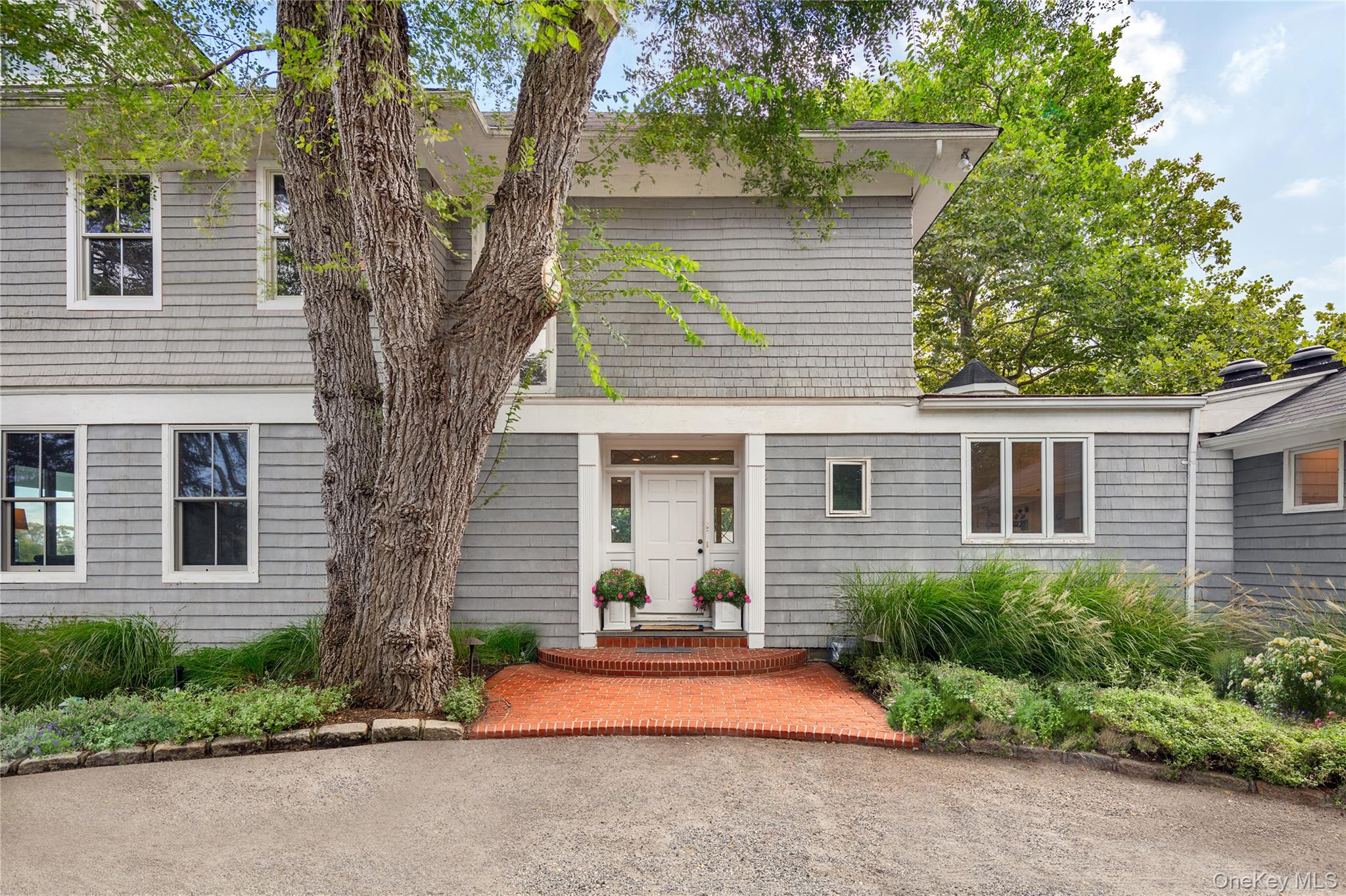11 Bay Road Quogue, NY 11959 - Photo 6 of 41 a front view of a house with a yard and garage