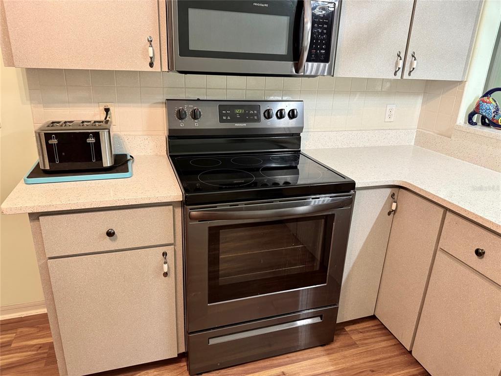 6008 Southwest 103rd Loop Ocala, FL 34476 - Photo 11 of 37 a stove top oven sitting inside of a kitchen