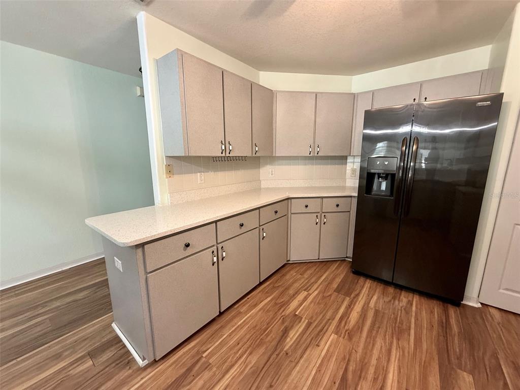 6008 Southwest 103rd Loop Ocala, FL 34476 - Photo 12 of 37 a kitchen with a sink window and cabinets