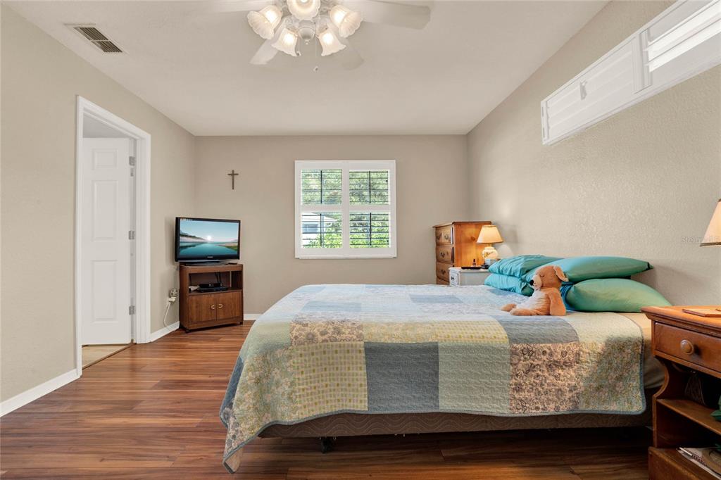 6008 Southwest 103rd Loop Ocala, FL 34476 - Photo 13 of 37 a bedroom with a bed and wooden floor