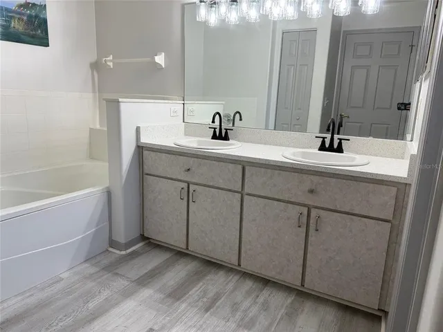 a bathroom with a bathtub and a sink