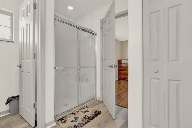 a bathroom with a glass door shower and a sink