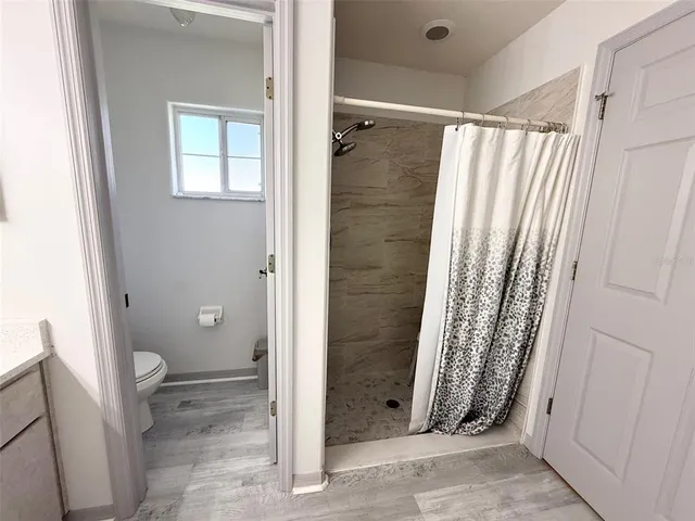 a bathroom with a double vanity sink mirror and shower