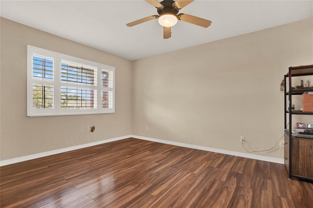 6008 Southwest 103rd Loop Ocala, FL 34476 - Photo 22 of 37 wooden floor in an empty room with a window