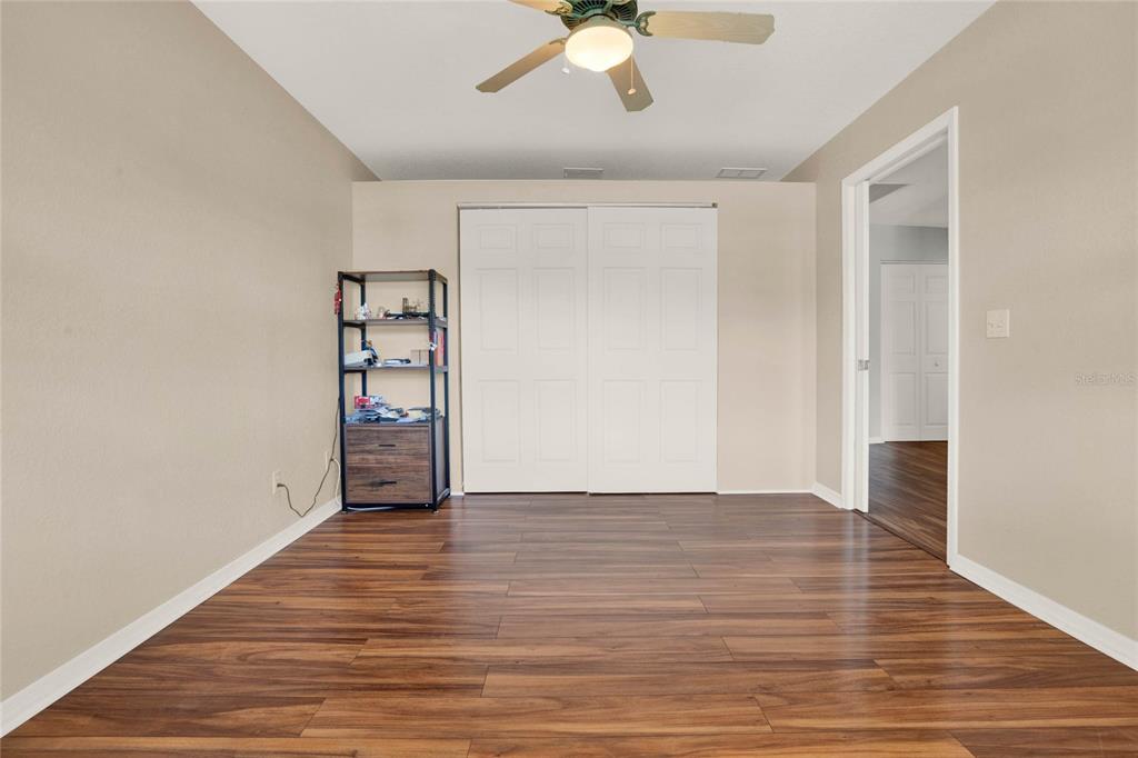 6008 Southwest 103rd Loop Ocala, FL 34476 - Photo 23 of 37 wooden floor in an empty room with a window