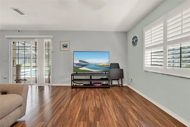 a view of a dining room with furniture window and wooden floor