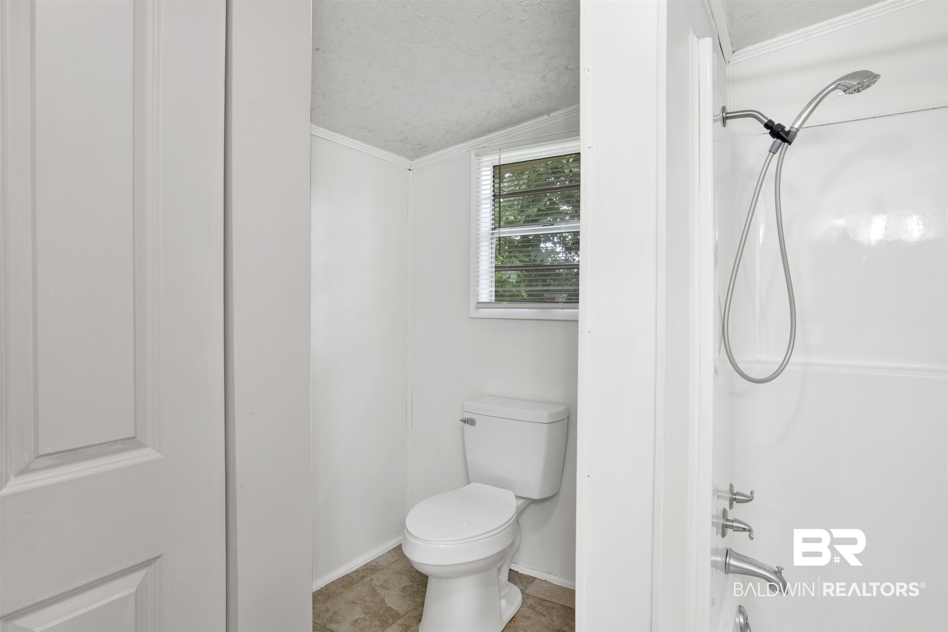 4265 Greaves Road Eight Mile, AL 36613 - Photo 17 of 34 Bathroom with shower / bath combination, ornamental molding, a textured ceiling, and tile patterned floors