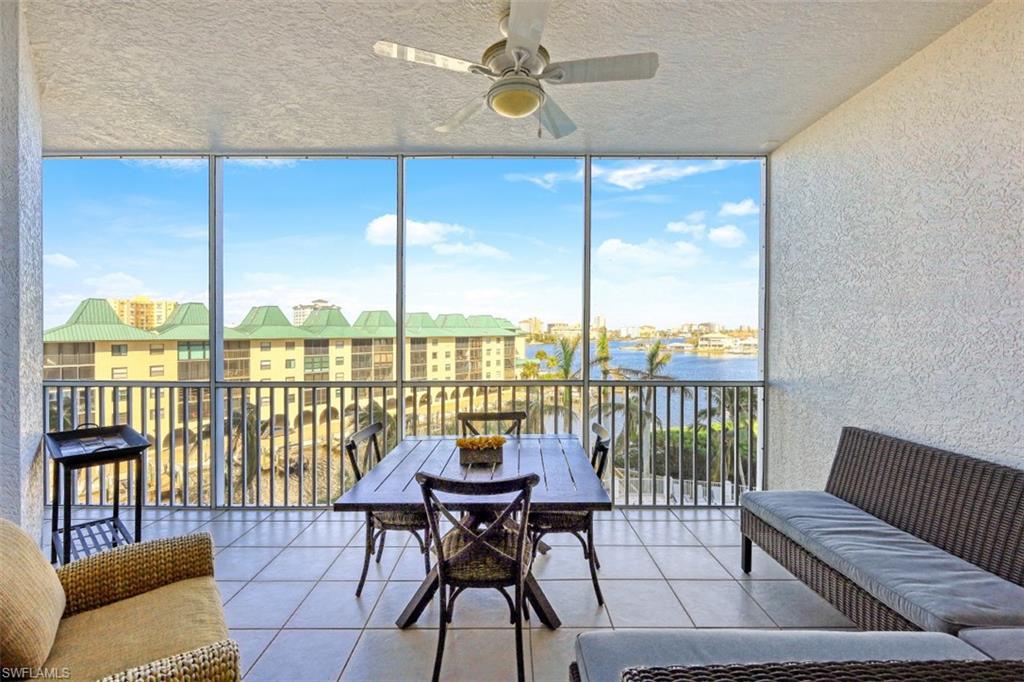 400 Flagship Drive, Unit 504 Naples, FL 34108 - Photo 9 of 38 Sunroom / solarium featuring a ceiling fan and a water view