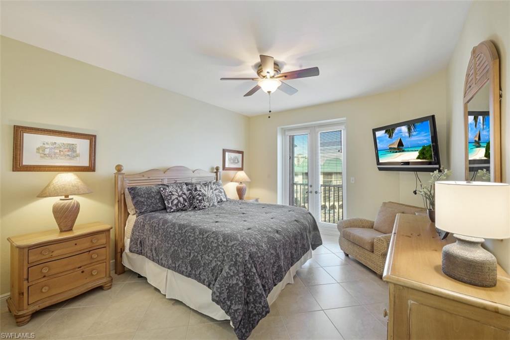 400 Flagship Drive, Unit 504 Naples, FL 34108 - Photo 10 of 38 Bedroom featuring light tile patterned floors, french doors, a ceiling fan, and access to outside