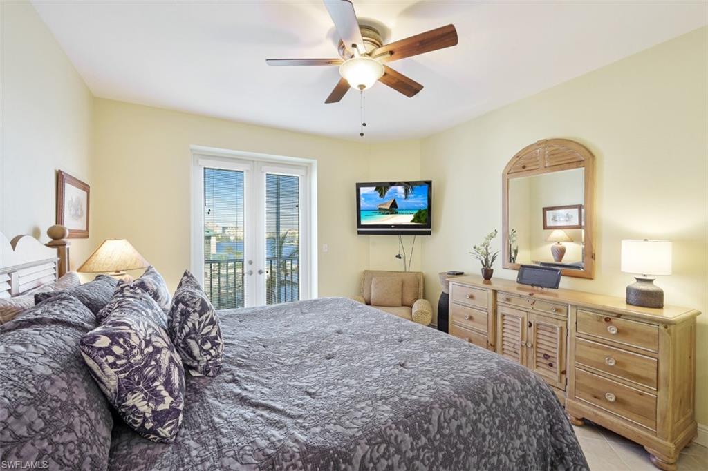 400 Flagship Drive, Unit 504 Naples, FL 34108 - Photo 11 of 38 Bedroom with light tile patterned floors, french doors, a ceiling fan, and access to outside