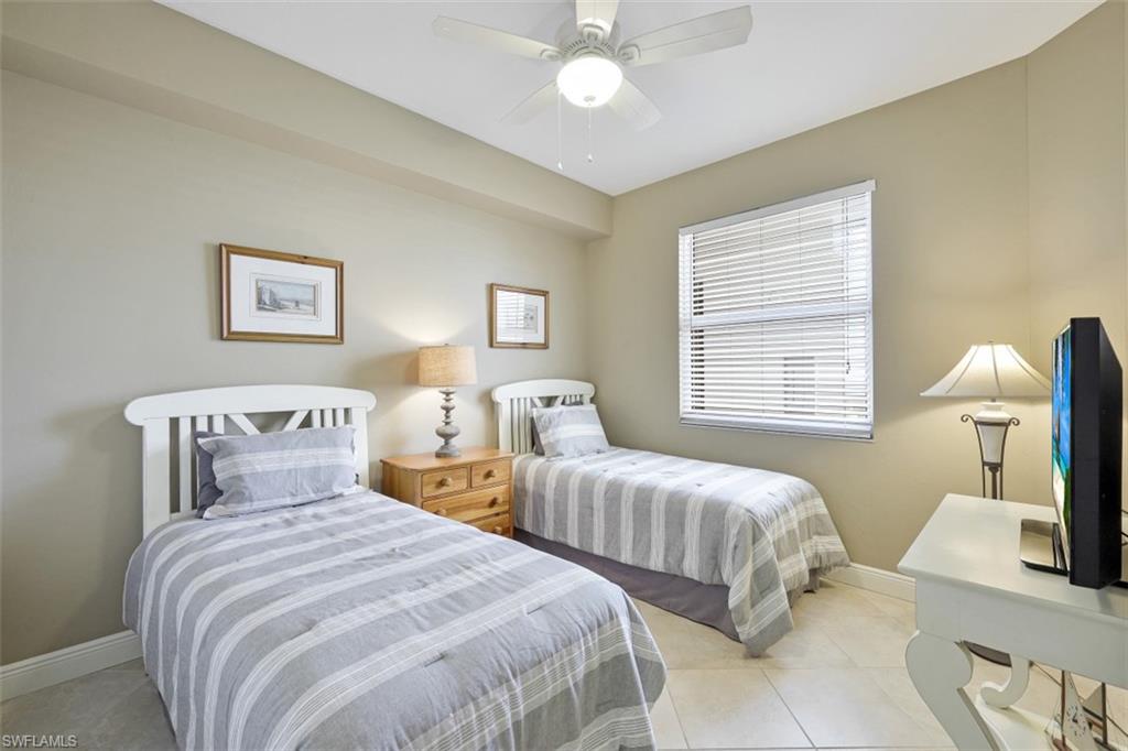 400 Flagship Drive, Unit 504 Naples, FL 34108 - Photo 14 of 38 Bedroom featuring light tile patterned flooring, ceiling fan, and baseboards