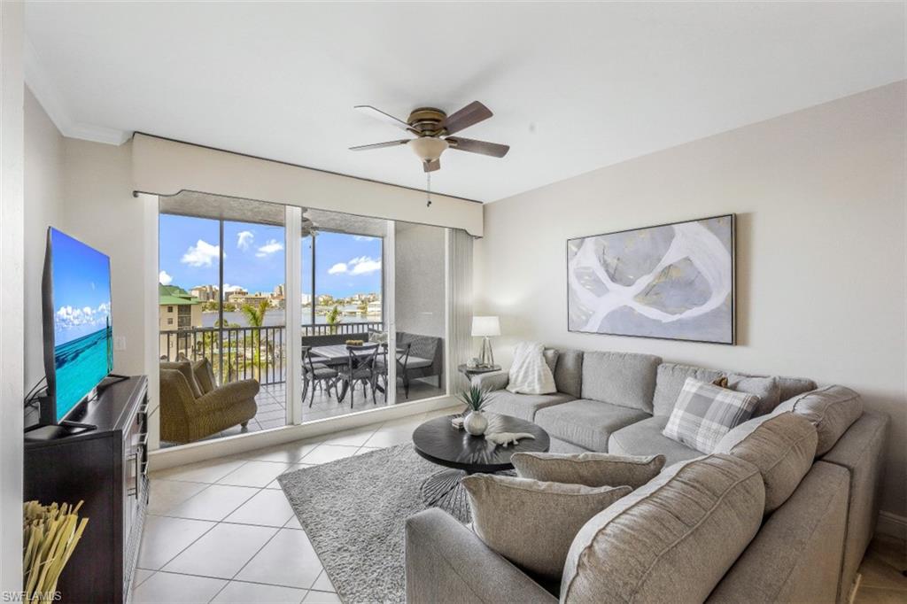 400 Flagship Drive, Unit 504 Naples, FL 34108 - Photo 22 of 38 Living room featuring light tile patterned flooring and a ceiling fan