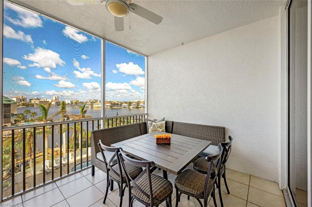 400 Flagship Drive, Unit 504 Naples, FL 34108 - Photo 25 of 38 Sunroom featuring a ceiling fan and a water view