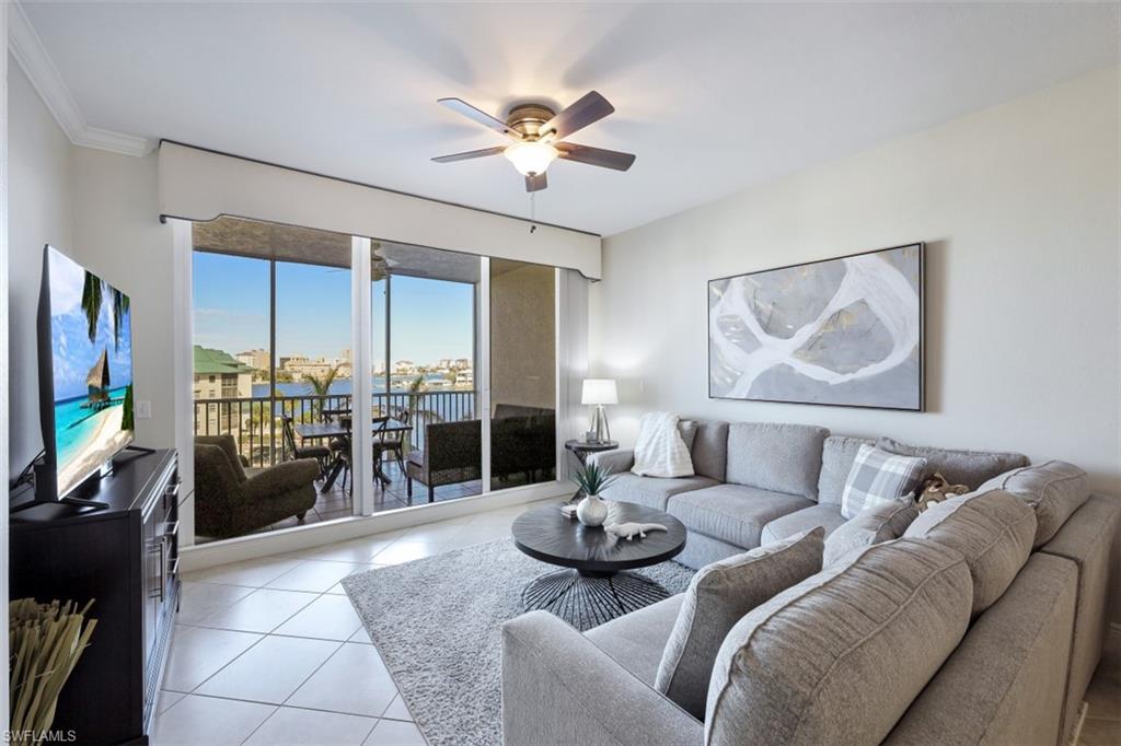 400 Flagship Drive, Unit 504 Naples, FL 34108 - Photo 4 of 38 Living area featuring light tile patterned floors, ceiling fan, and crown molding
