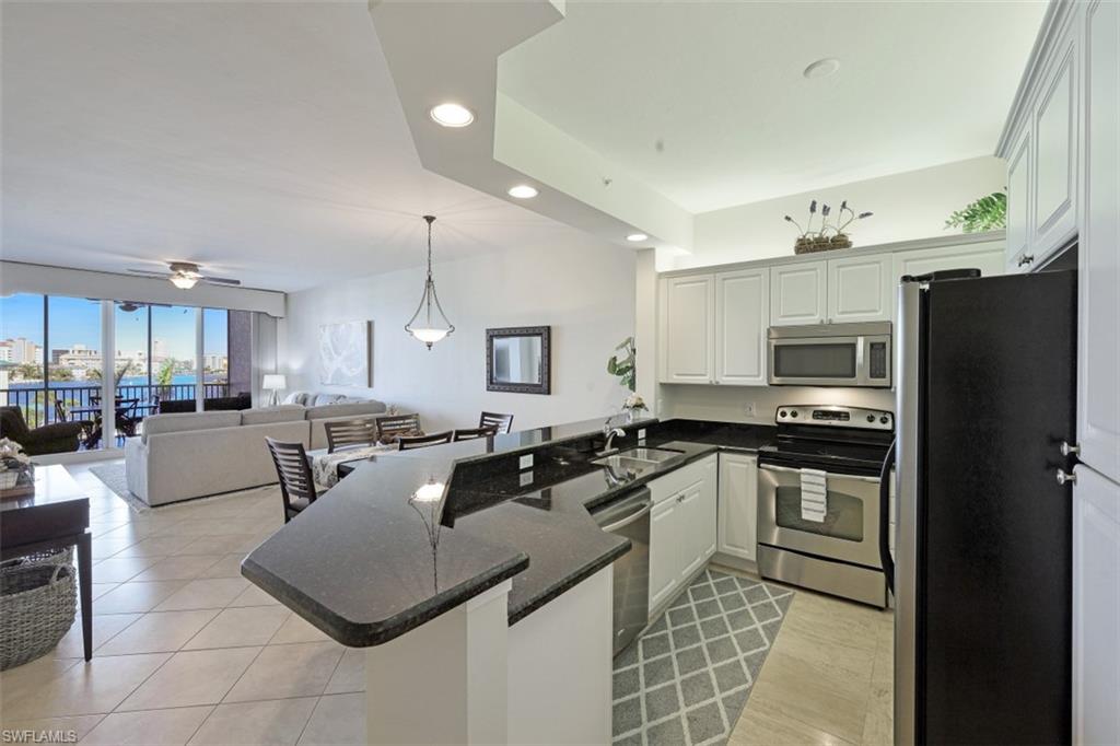 400 Flagship Drive, Unit 504 Naples, FL 34108 - Photo 38 of 38 Kitchen with open floor plan, a peninsula, stainless steel appliances, and a sink