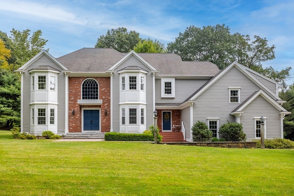 40 Corn Road Bolton, MA 01740 - Photo 1 of 1 a front view of a house with a garden