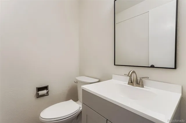 a bathroom with a sink a toilet and mirror