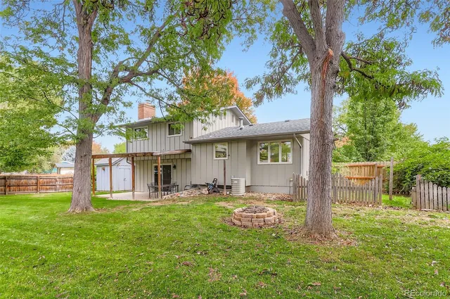 a front view of a house with a yard table and chairs