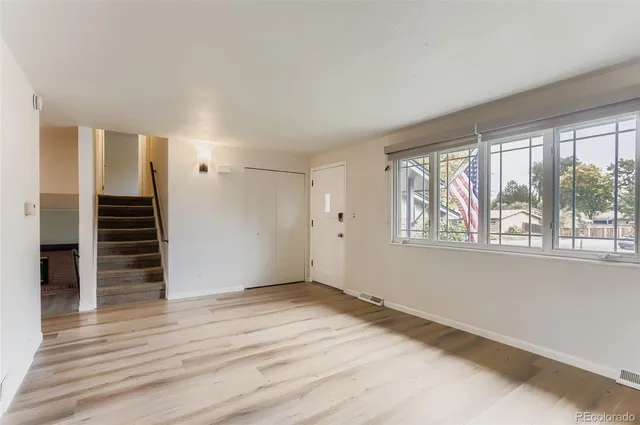 wooden floor in an empty room with a window