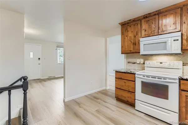 a kitchen with stainless steel appliances granite countertop a stove and a microwave