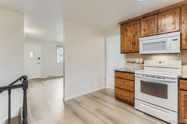a kitchen with stainless steel appliances granite countertop a stove and a microwave