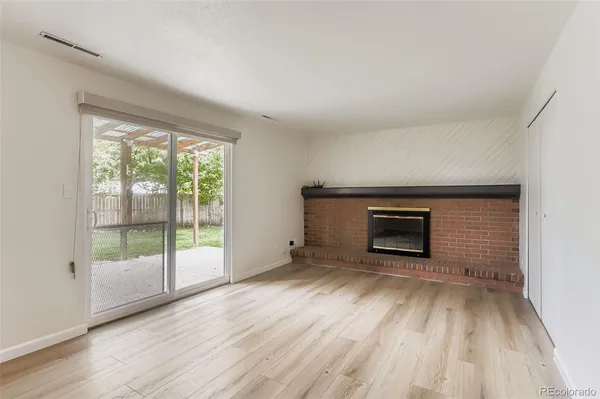 wooden floor fireplace and natural light in room