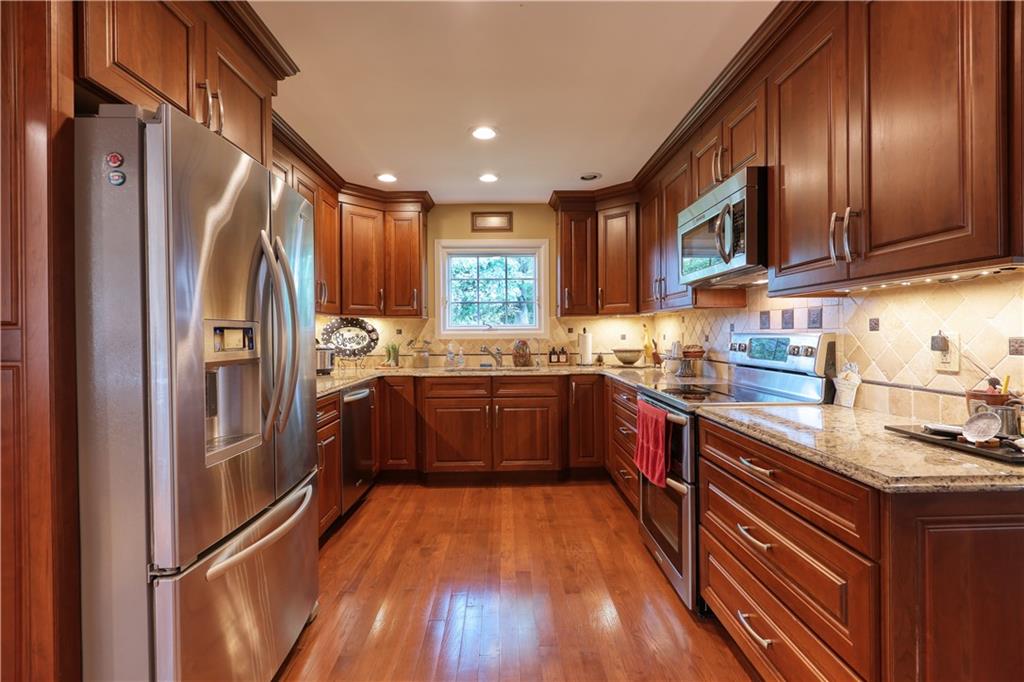 514 Pleasant Hill Road Hookstown, PA 15050 - Photo 6 of 25 a kitchen with stainless steel appliances granite countertop a refrigerator a sink dishwasher a stove and a dining table with wooden floor