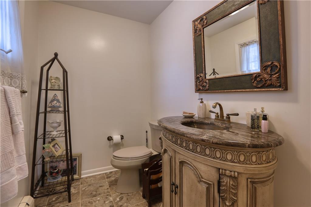 514 Pleasant Hill Road Hookstown, PA 15050 - Photo 9 of 25 a bathroom with a granite countertop toilet sink and mirror