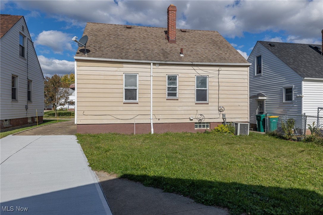 16002 Turney Road Maple Heights, OH 44137 - Photo 5 of 29 Rear view of property with a chimney, a yard, and a shingled roof